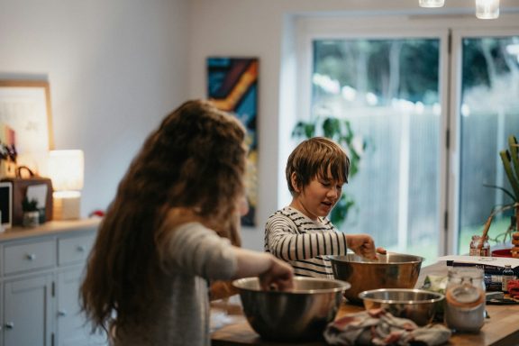 Two children cooking in the kitchen.